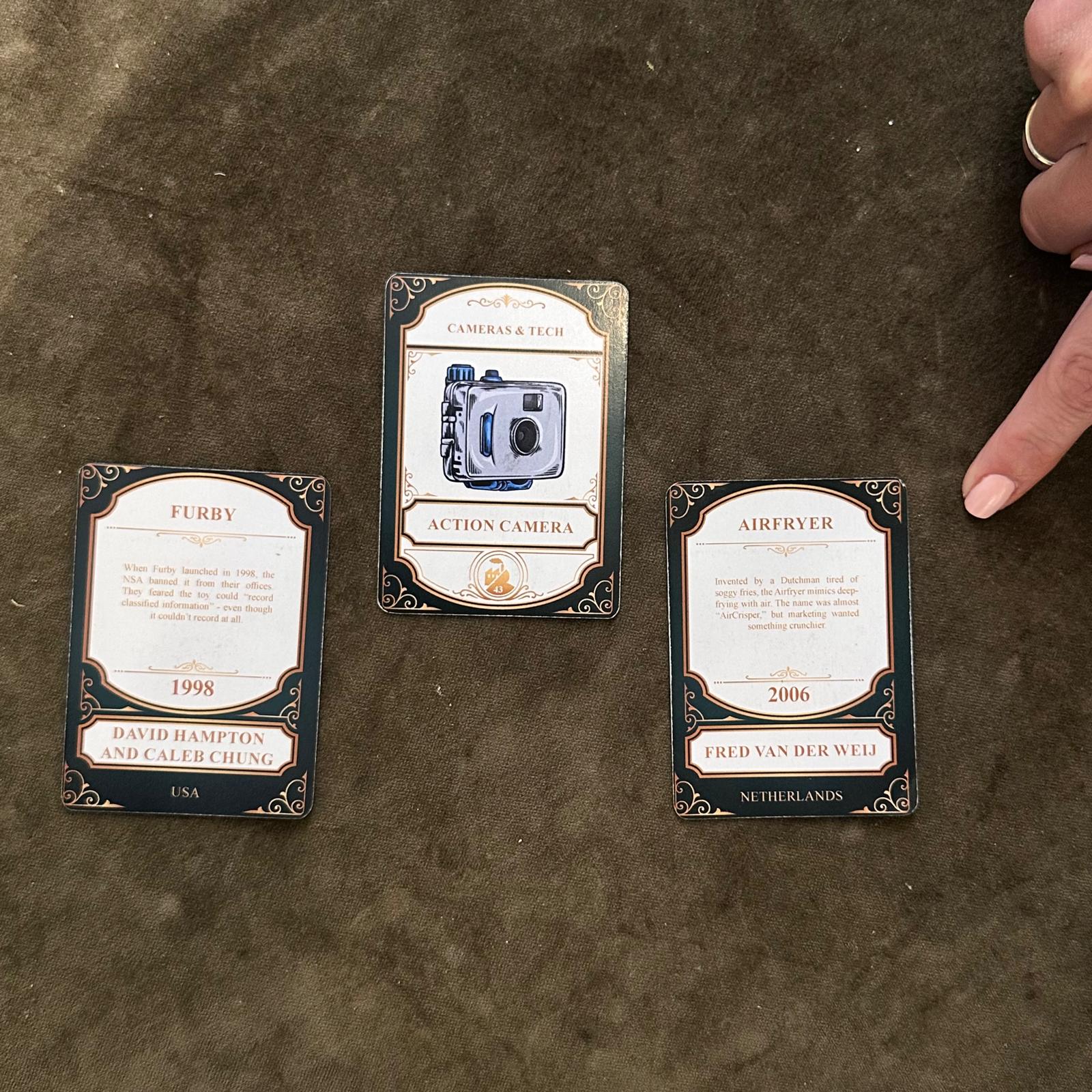 Three cards on the table, one showing the action camera invention